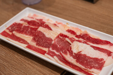Delicious fresh raw juicy kobe wagyu marbled beef pork meat slice on plate ingredient for food sukiyaki yakiniku steak healthy meal Japanese traditional dining culture restaurant high protein bar-b-q