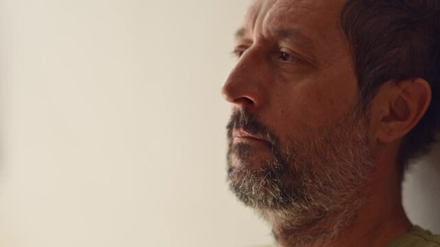 Regretful man alone in living room, 4K