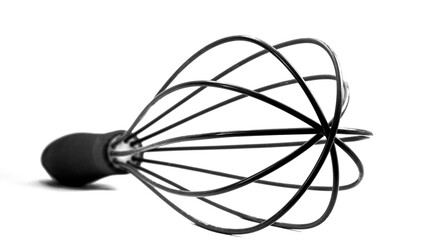 Whisk or egg beater close up. Black and white photo.