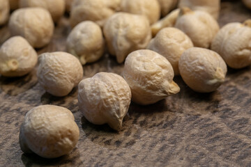 Raw chickpeas on a wooden board. Dry chickpea close up.