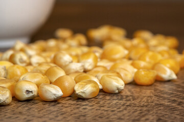 close up of a pile of corn seeds on wooden table