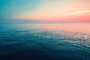 Obraz premium Tranquil Ocean at Dusk with a Pink and Blue Sky