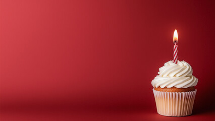 Birthday cupcake with white cream and a burning candle. Red background, empty space for text. Template for a postcard, invitation, flyer.