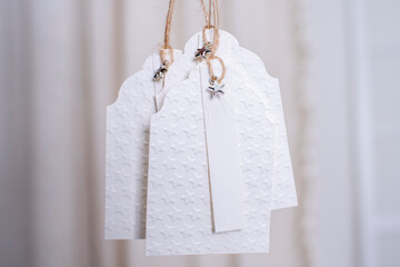 Selbstgemachte Geschenkeanhänger aus geprägtem Papier mit verschiedenen winterlichen /...