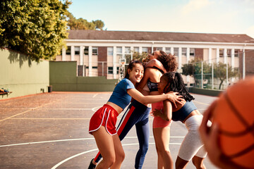 Basketball, game and outdoor hug with people, fitness and group diversity for celebration. High school team, girls and court for sport practice or embrace at match, training and athletes for win