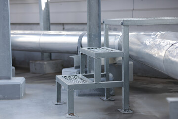 Expanded metal mesh ladder for walking across pipe work to reduce damage to equipment. Steel ladder for crossing cold water pipe system.