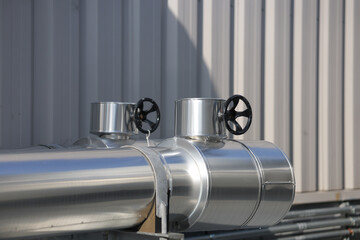 Pipe jacket aluminum work point where the  handwheel operated valve protrudes. Insulation work for cold water pipes to prevent condensation.