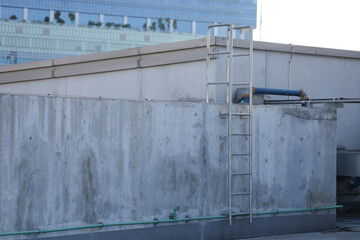 Fixed ladder for working on the roof. Fixed ladder are installed next to the wall for climbing to the next level.