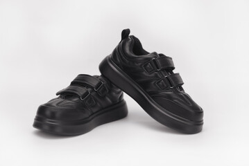 Stylish sneakers featuring Velcro straps, designed for comfort and ease of use, displayed against a clean white background, representing modern footwear fashion
