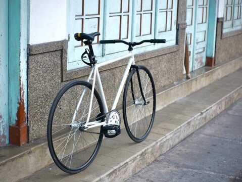 fixie bike leaning against an old wooden wall