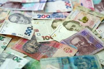 Big amount of different ukrainian hryvnia currency money bills in pile