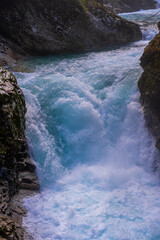gorge with a river in the mountains, blue water, blue river, waterfalls, rocks and mountains