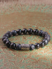 Black Obsidian stone bracelet , Chinese men's modern retro style fashion. Isolated on white...