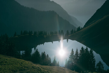 Silhouettes of Mountains Reflected in the Serene Waters of Alpsee Near Nebelhorn