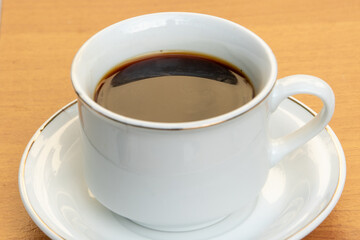 Black Coffee in Ceramic Cup on Wooden Table