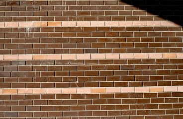 A brick wall with a red stripe