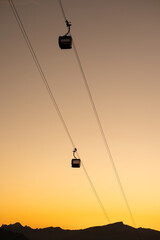 Silhouettes of the Alps at Sunset with a Cable Car Journey into the Mountains