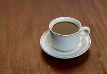 Black Coffee in Ceramic Cup on Wooden Table