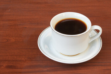 Black Coffee in Ceramic Cup on Wooden Table