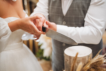 Experience the joy of an intimate wedding cake cutting ceremony featuring an elegant and beautiful bride alongside her charming groom