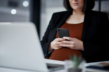 Woman, hands and pregnant with smartphone at office on internet or website for booking or consultation with gynecologist. Female person, fertility and texting as employee on pregnancy app for health