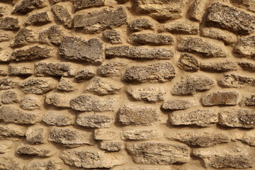 Wall constructed from irregularly shaped stones rustic appearance
