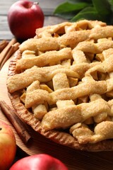 Tasty homemade apple pie and ingredients on table, closeup