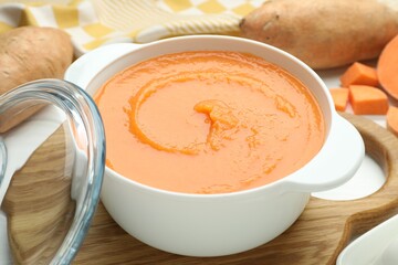 Delicious sweet potato soup on white table, closeup