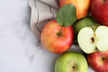 Different ripe apples on white table, flat lay. Space for text