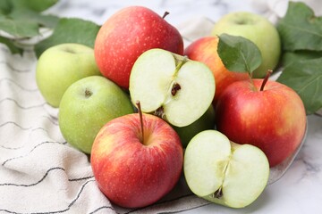 Different ripe apples on white table, closeup
