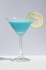 Blue cocktails garnished with blueberry and a slice of lemon