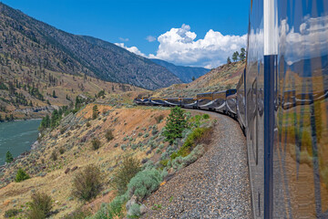 Rocky Mountaineer train by Fraser River between Vancouver and Kamloops, British Columbia, Canada.