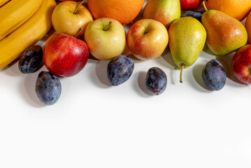 frame with fresh sliced fruits on a white background. frame with oranges, grapefruit, pears and plums on a white background