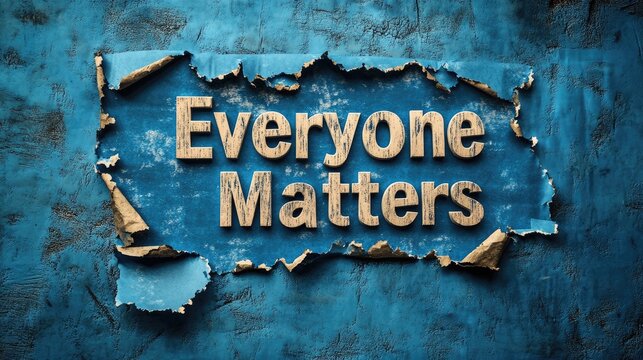 Blue paper backdrop showcasing the phrase "Everyone Matters" on a piece of torn paper, symbolizing inclusivity and significance.