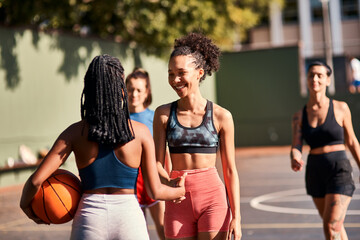 Sport, handshake and women with ball, outdoor and camaraderie of athletes, basketball court and match. Playing, shaking hands and people with respect, cheerful and gesture of sportsmanship and team