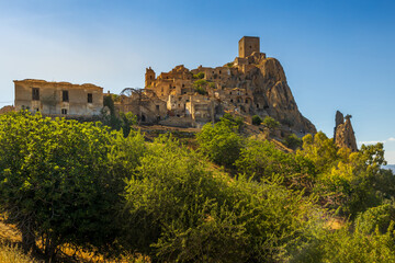 A picturesque view of the abandoned, old mountain town of Craco, built of sandstone rock. Craco is a ghost town abandoned due to an earthquake in the late 20th century. Province of Matera, Basilicata,