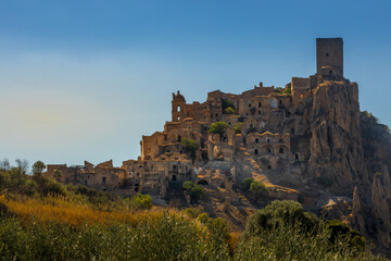 A picturesque view of the abandoned, old mountain town of Craco, built of sandstone rock. Craco is a ghost town abandoned due to an earthquake in the late 20th century. Province of Matera, Basilicata,