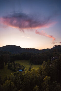 Landscape with purple clouds and forest in foreground, Hrensko, Czech republic