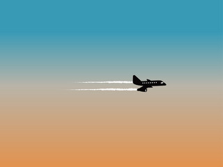 An aeroplane flying over a silhouetted sky at sunset time