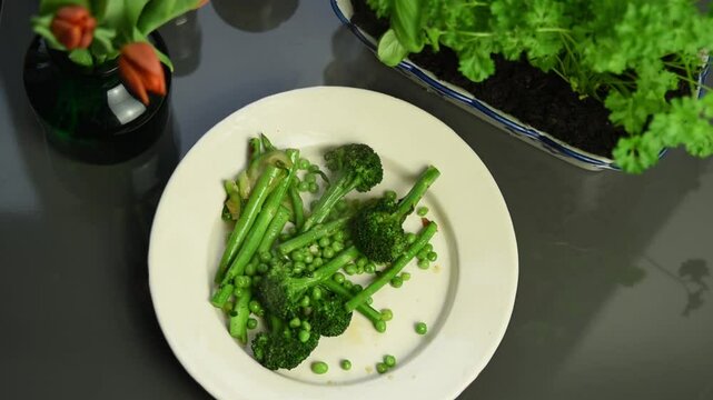Steamed green vegetables served on a white plate, top view food video, 1920x1080, HD, plating food, healthy lifestyle