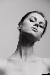 Elegant portrait of a confident woman in black and white, showcasing her graceful neck and serene...