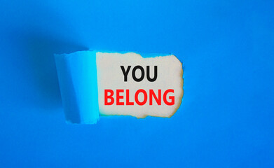 Belonging and you belong symbol. Concept words You belong on beautiful white paper. Beautiful blue paper background. Business belonging and you belong concept. Copy space.