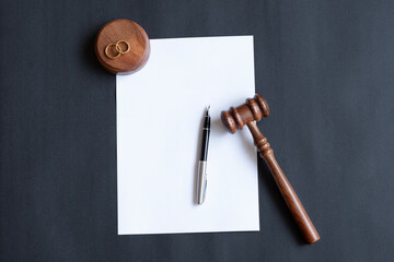 Divorce decree or marriage contract. Judge gavel with wedding rings and divorce decree. Marital...