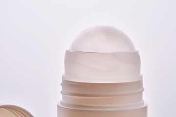 Roll-on deodorant on a background with beige grooves.