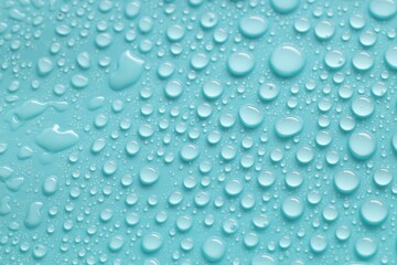 Water drops on turquoise background, above view