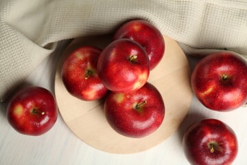 Fresh ripe red apples on white wooden table, above view