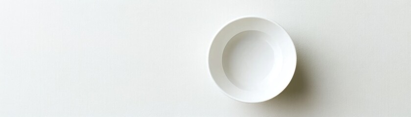 White Oval Ceramic Bowl on a White Surface