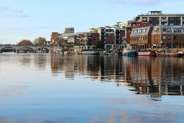 Mirror-like reflection of Kingston Upon Thames quayside on the River Thames