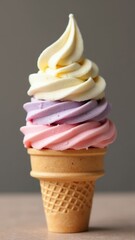 Delicious Swirl of Pastel Ice Cream Flavors Served in a Classic Waffle Cone