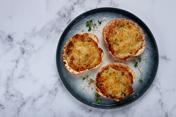 scallop shells, stuffed, baked with cheese, in the oven, julienne with scallops,